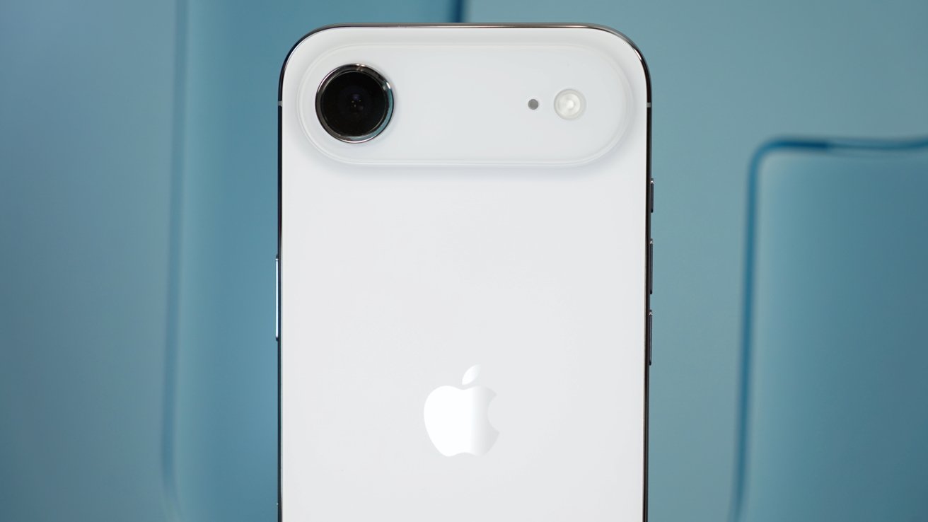 White smartphone with a single rear camera and flash on top left, featuring an Apple logo below, set against a soft blue background.