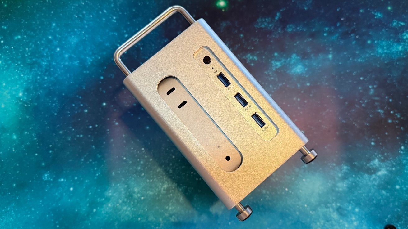 Silver computer case with USB ports, power switch and vents, set against a cosmic starry background.