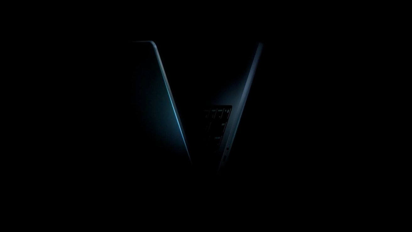 Partially open laptop on a dark background with subtle blue highlights on the edges.
