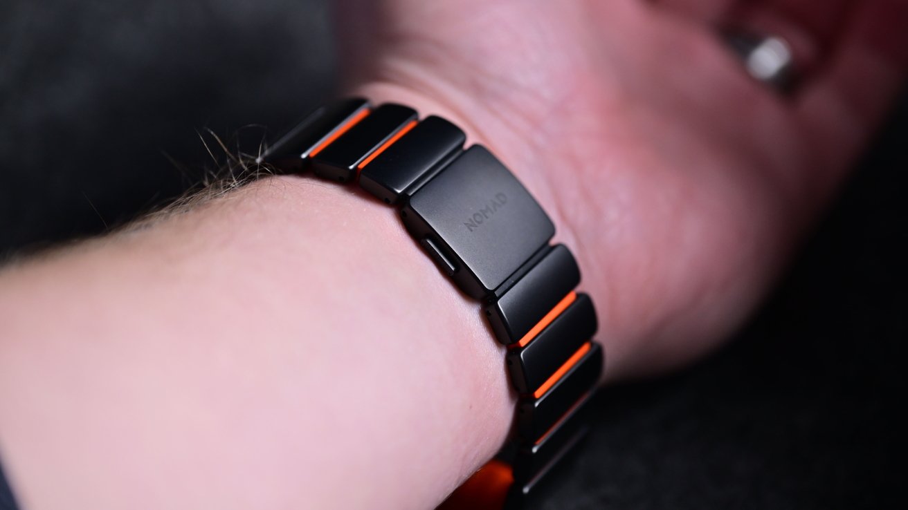Black and orange metal wrist strap with 