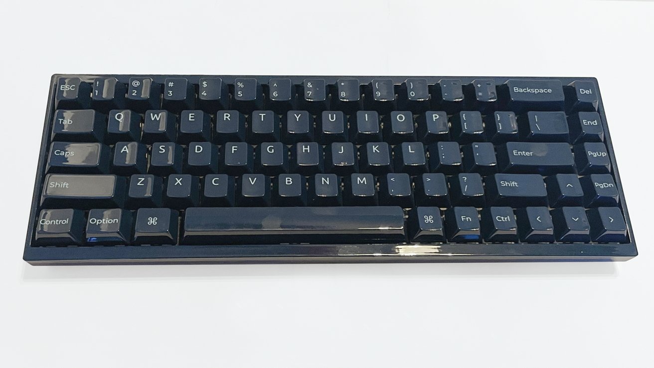 A compact black keyboard with dark keys, set against a white background.