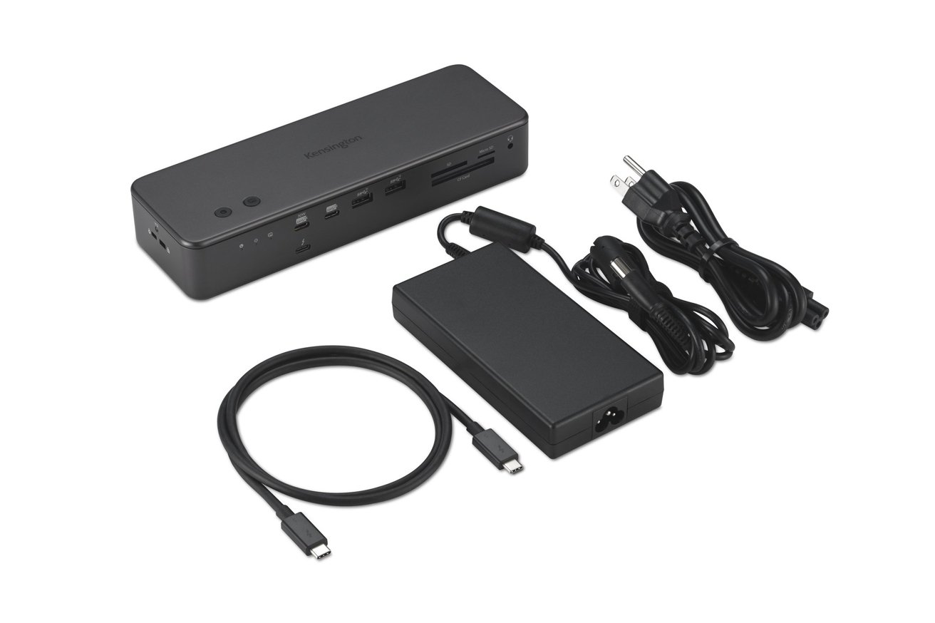 Black rectangular docking station with various ports, a large power adapter, USB-C cable, and power cords on a white background.