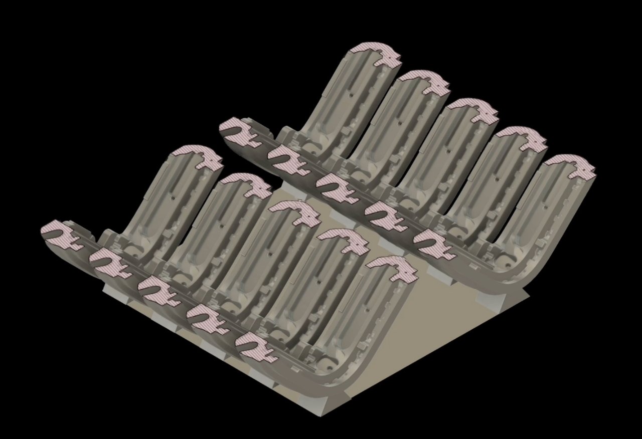 Gray and pink mechanical components arranged in two angled rows on a dark background.