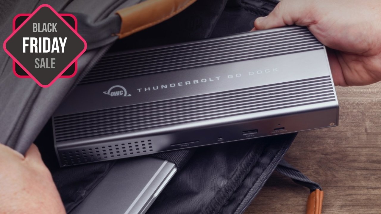Hand holding an OWC Thunderbolt Go Dock being placed into a bag, with a Black Friday sale label in the corner.