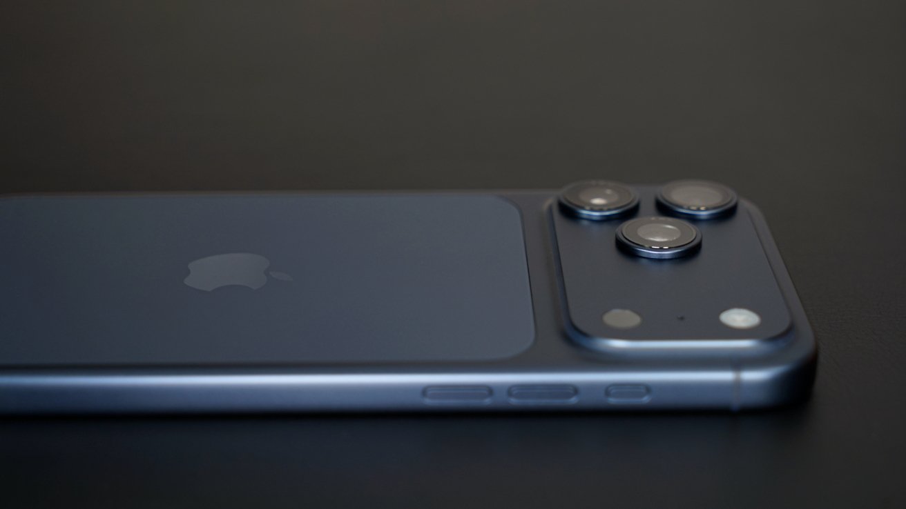 A sleek blue smartphone lies on a dark surface, displaying three prominent camera lenses and buttons on the side.