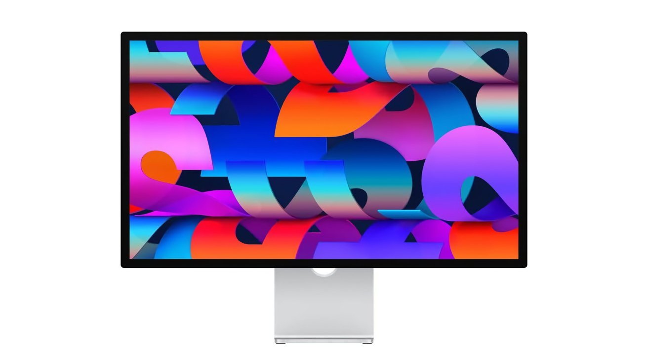 The elegant monitor displays a vibrant abstract pattern on a silver stand with overlapping shapes in vibrant colors such as blue, pink, orange and purple.