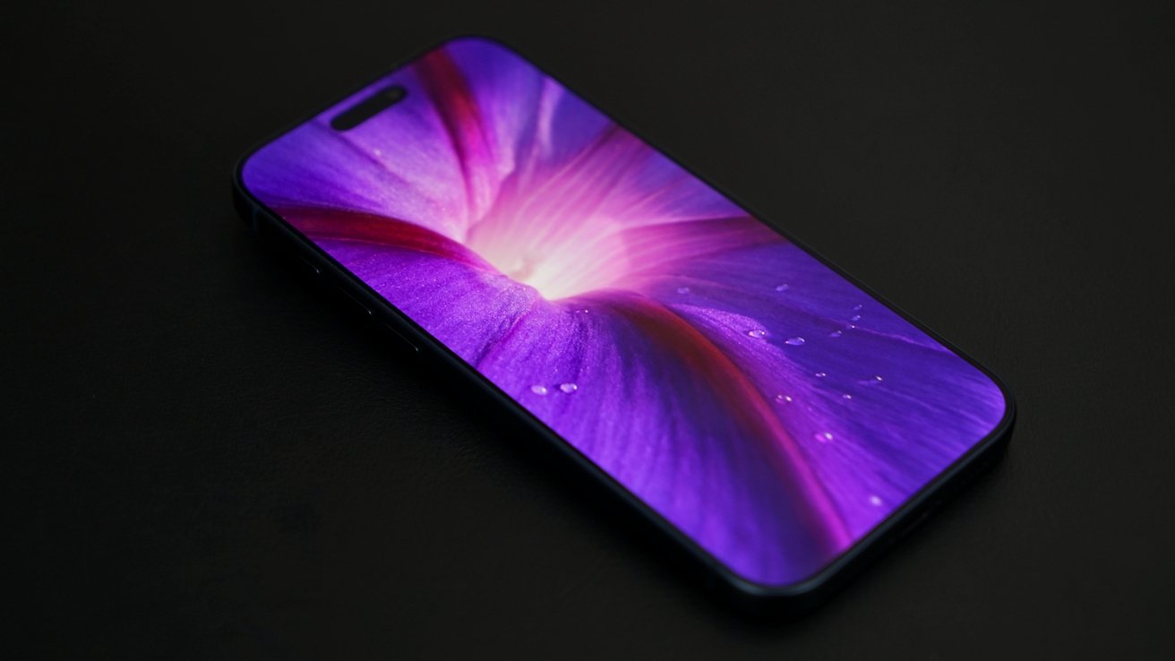 A smartphone with a vivid, glowing purple and pink abstract wallpaper displayed, placed on a dark surface.
