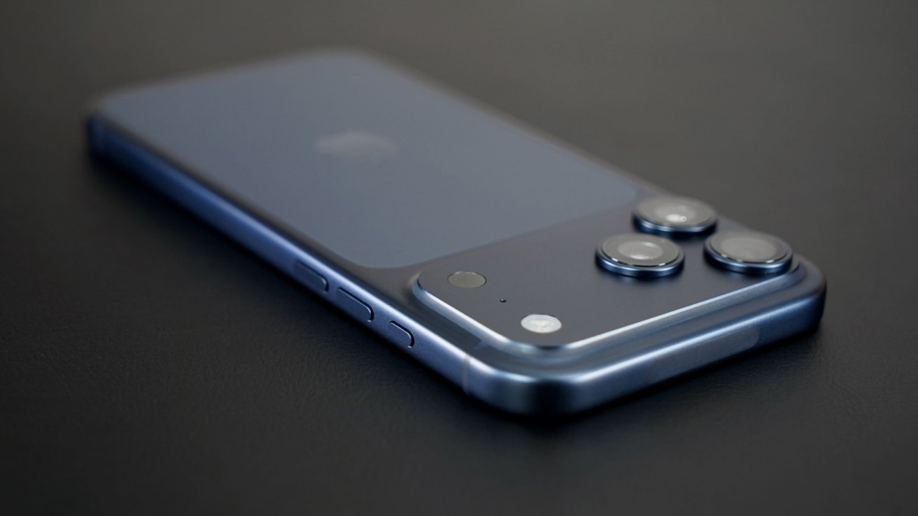 Blue smartphone with triple-lens camera and shiny metal edges lying on a dark surface, viewed from a low angle.