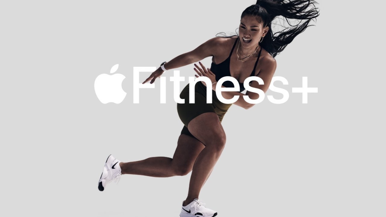 Woman in athletic wear mid-stride on grey background, hair flying back, with Apple Fitness+ logo overlay.