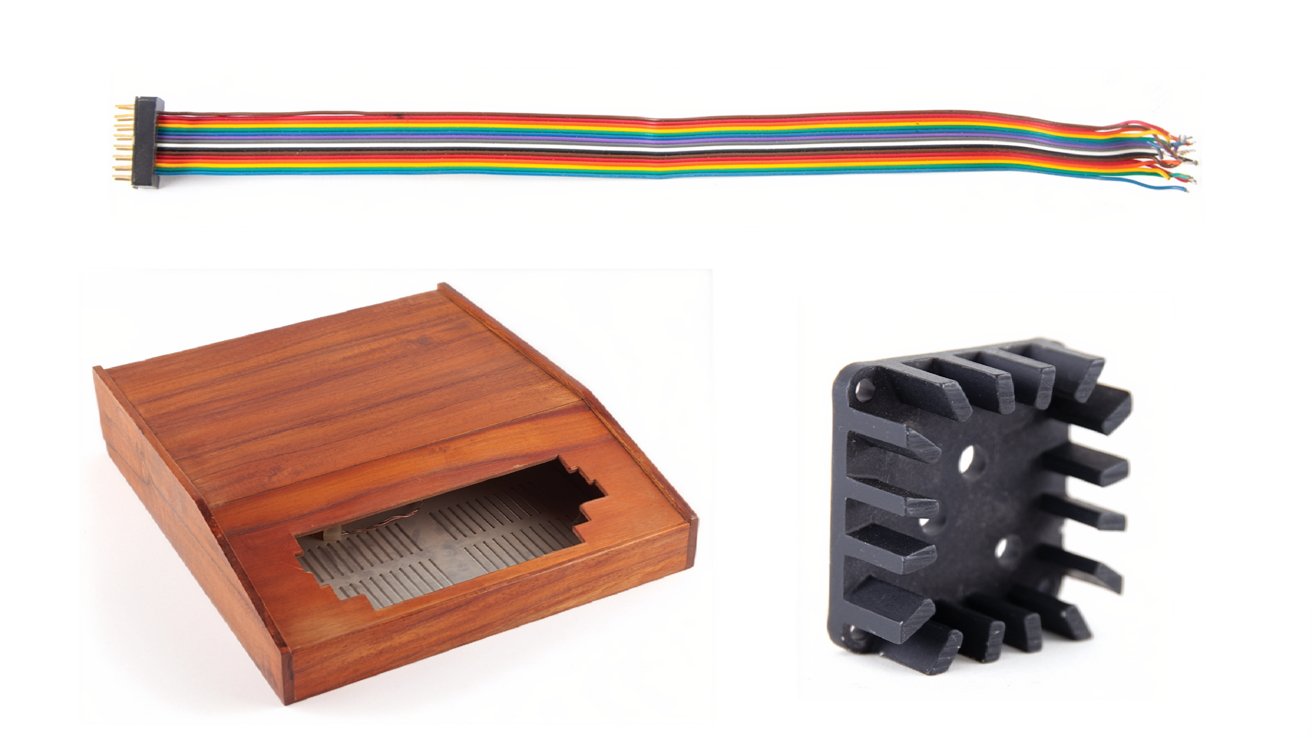 Colorful ribbon cable, wooden inlaid box with an open front, and black rectangular heatsink with multiple fins.