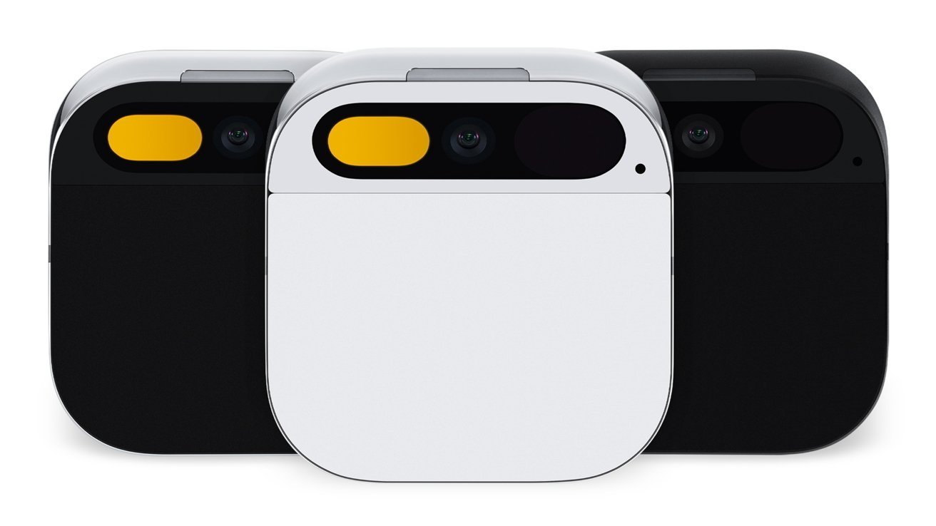Three compact, rounded square camera devices, front-facing, with minimalist design; white unit in center flanked by two black units, each showing a wide pill-shaped camera and yellow accent light