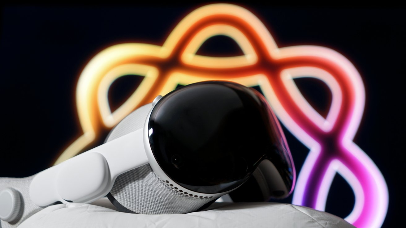 Apple Vision Pro headset with glossy black front rests on a cushion, set against a dark background featuring a glowing, multicolored infinity-shaped neon light.
