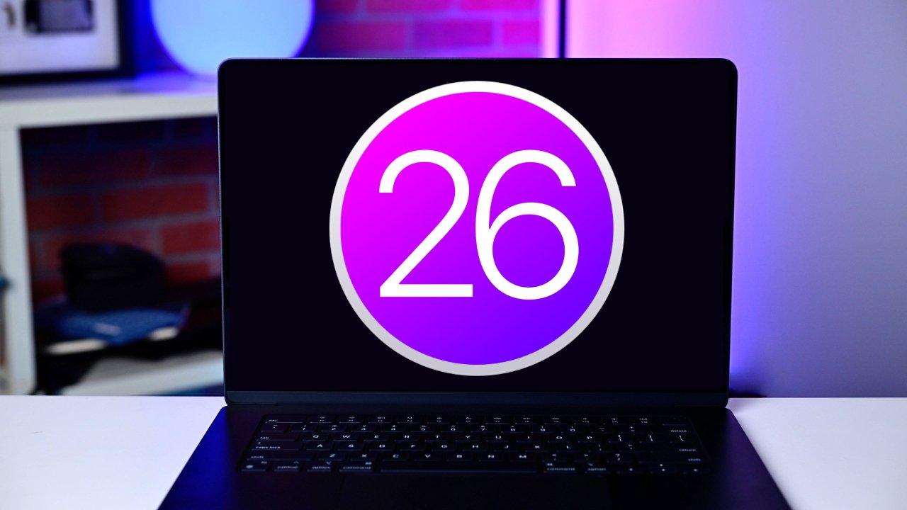 Open laptop on a desk displaying a large purple circle with the number 26 in white, against a dark screen and softly lit colorful background.