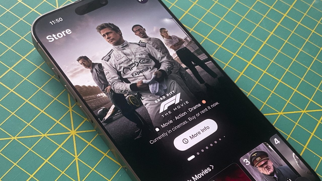 Smartphone displaying a movie store screen featuring a racing drama poster with drivers in racing suits, resting on a green cutting mat with yellow grid lines.