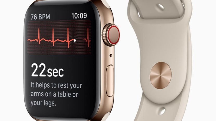 Gold Apple Watch showing 76 BPM heart rate and red ECG line, 22 second countdown with rest instructions, attached on a light beige sports band