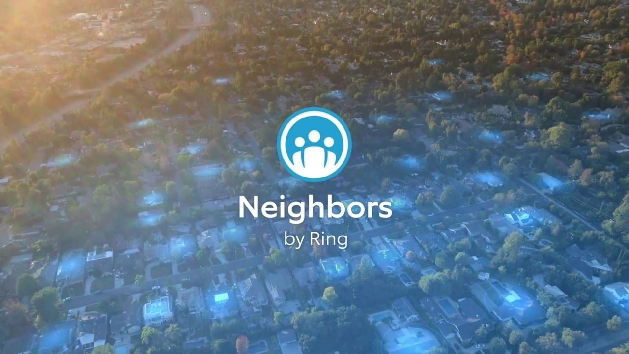 Aerial view of a sunlit suburban neighborhood with blue glowing areas over houses, centered Neighbors by Ring logo featuring three stylized people in a blue circle.