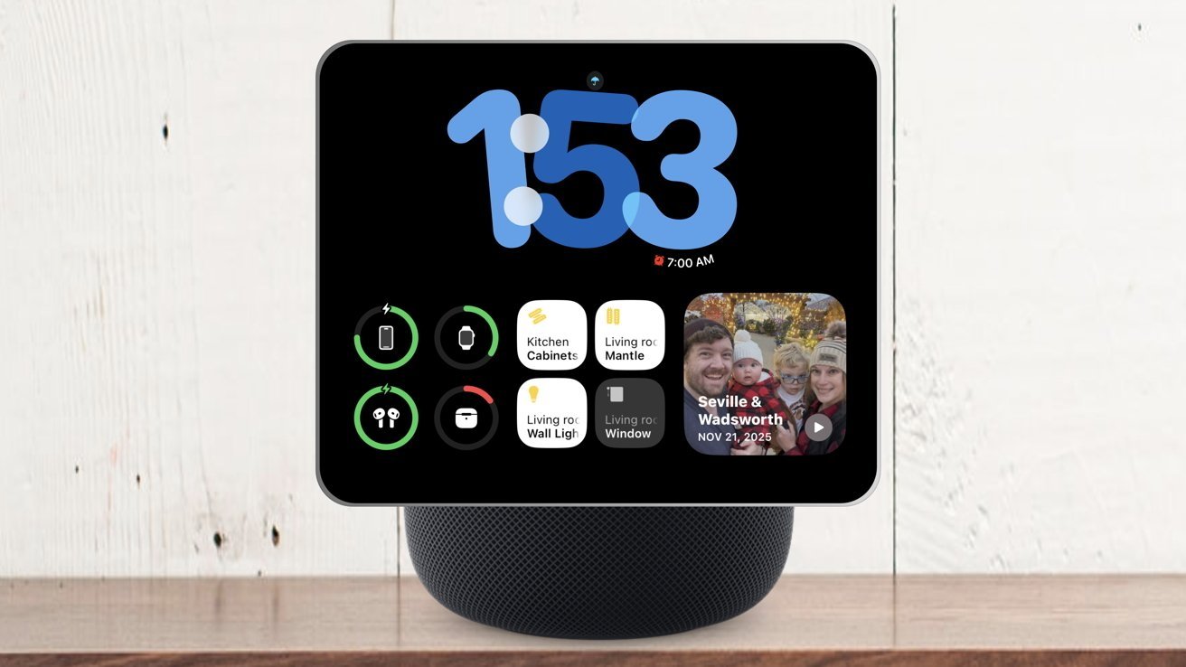 Smart display on round smart speaker showing big digital clock, battery icons, smart home control and family photo widget on black screen on wooden surface with white wall background