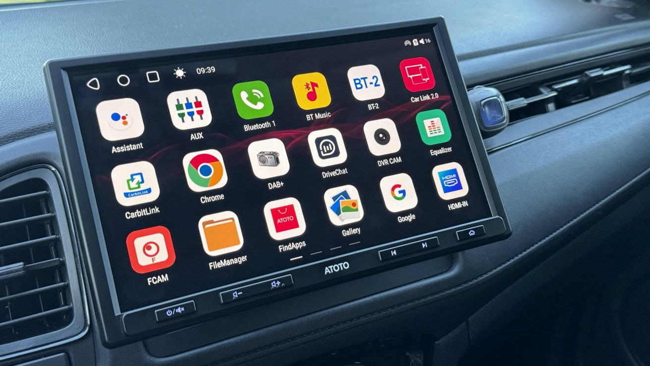 Large touchscreen car stereo displaying colorful app icons on a dark background, labeled with functions like navigation, Bluetooth, music, Chrome, camera, gallery, and settings within a modern dashboard