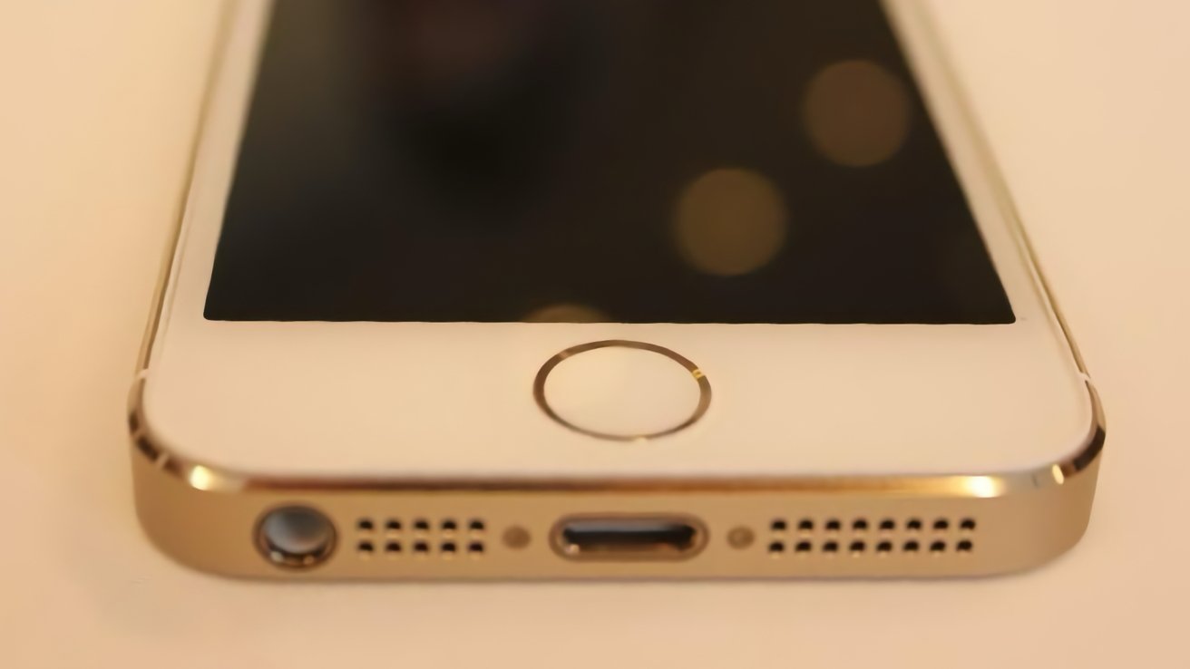 Close-up photo of the gold iPhone 5s Touch ID button.