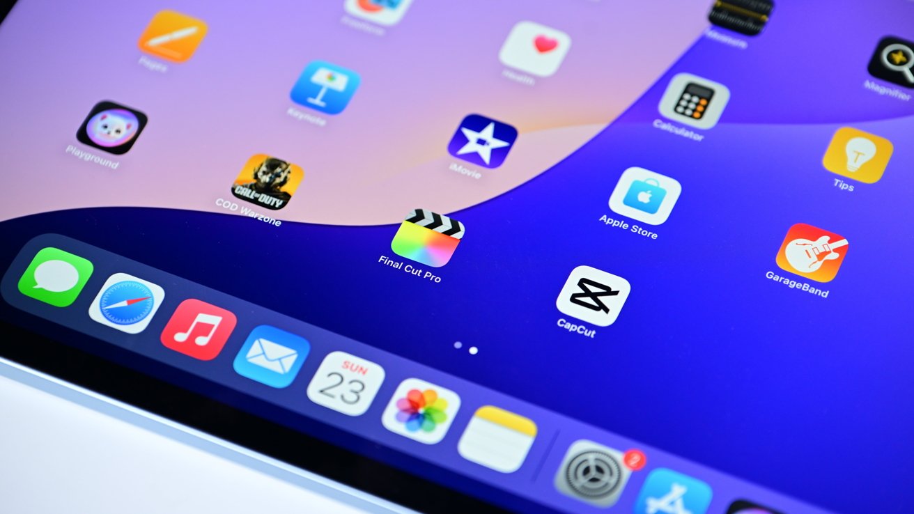 An iPad Air laying on a surface with the Home Screen shown. It has multiple icons and dock in view.