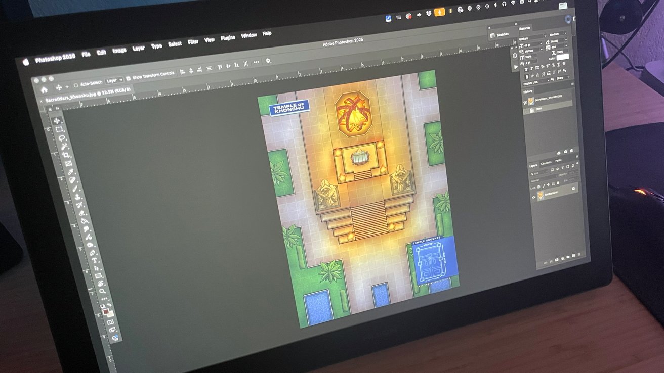Tablet screen showing Adobe Photoshop with a colorful top-down temple map open, featuring glowing central altar, statues, surrounding greenery, pools, and a small blue floor-plan inset