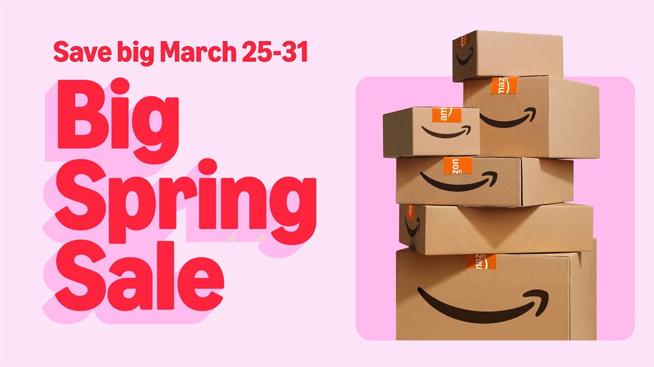 Pink graphic reading Big Spring Sale and Save big March 25-31 beside a tall stack of Amazon shipping boxes with smile logos and orange tape