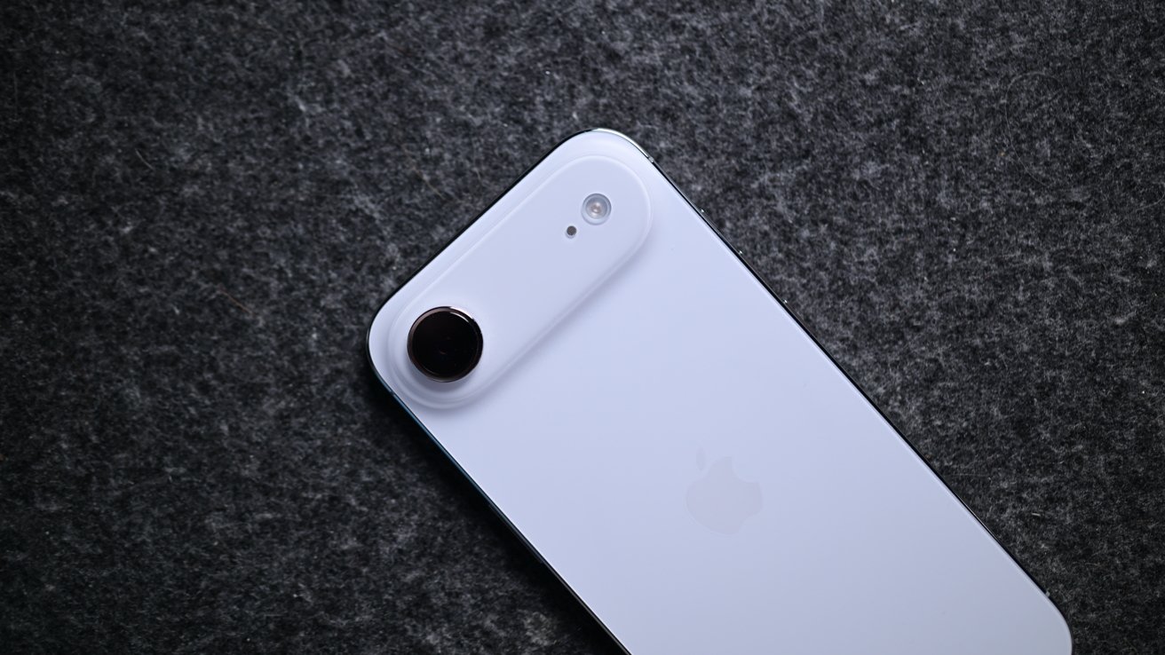 iPhone Air in blue facedown on a cloth surface showing its camera bar and single lens