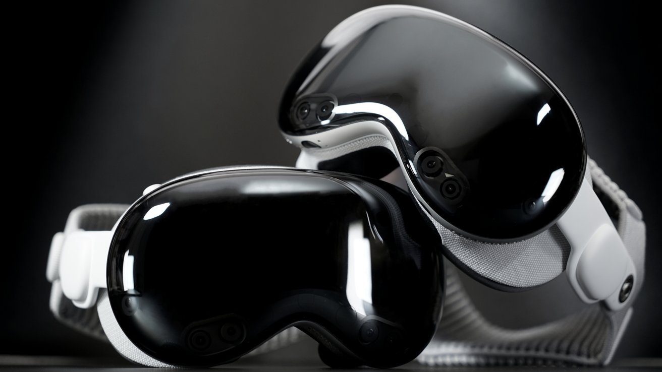 Two sleek, reflective black VR headsets with white fabric straps lying overlapping against a dark background, showing their curved lenses and small front-facing cameras