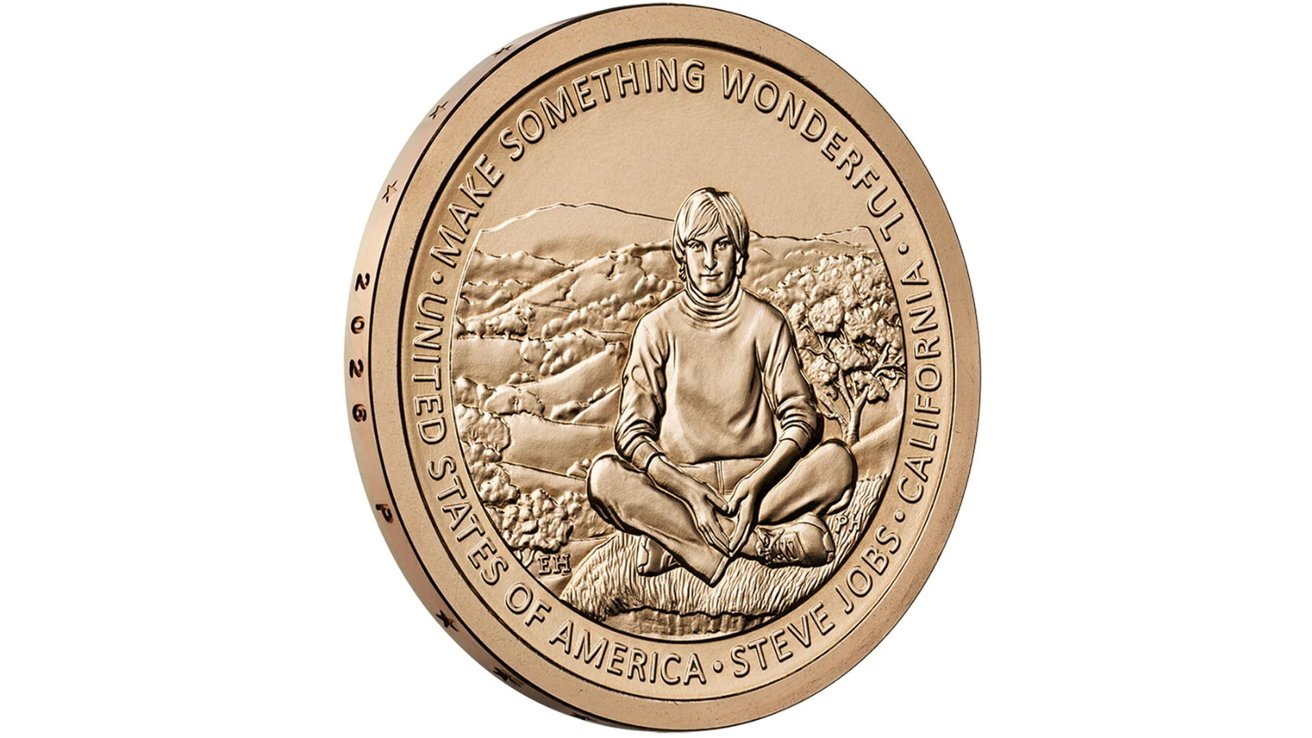 Bronze commemorative coin showing Steve Jobs sitting crosslegged on grass before rolling hills, surrounded by text: Make Something Wonderful, United States of America, Steve Jobs, California, 2026